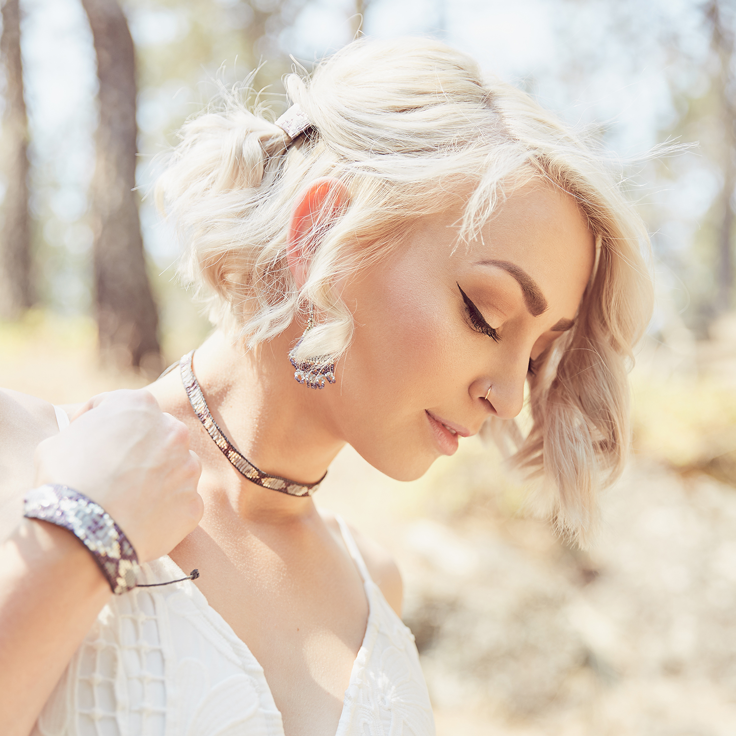 boho bride in purple jewelry and white